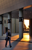 Man walking in front of pillars at Docklands, sunset